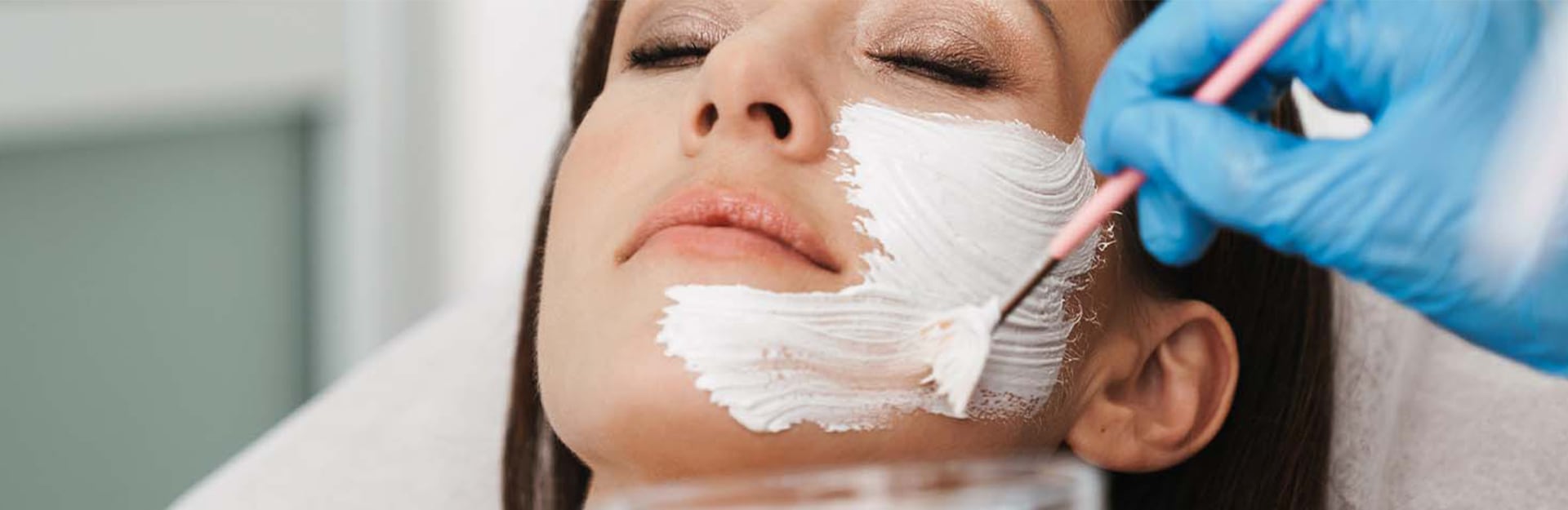 woman receiving facial treatment at luxurious spa.