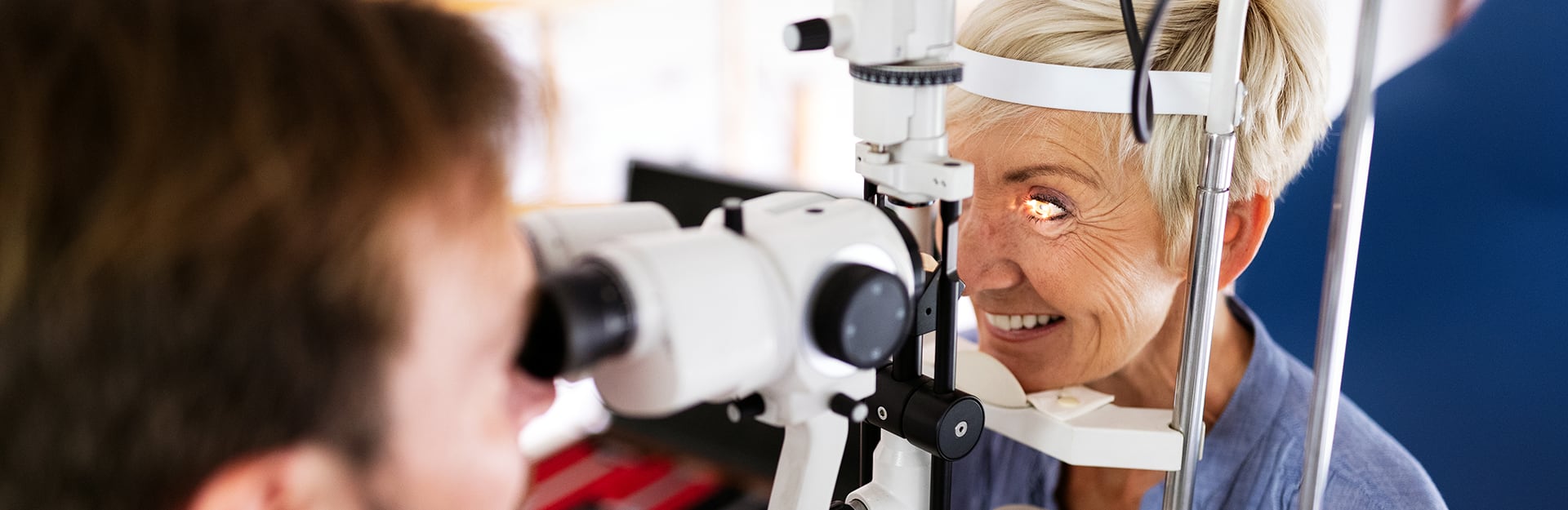 hero image for diabetic eye exams showcasing an optometrist performing comprehensive eye exam on patient.
